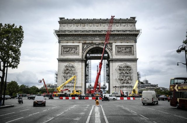 A picture taken on august 4, 2021, in paris shows the sculptures and the arc de triomphe being prepared before the wrapping of the monument.   (photo credit: stephane de sakutin/afp via getty images)