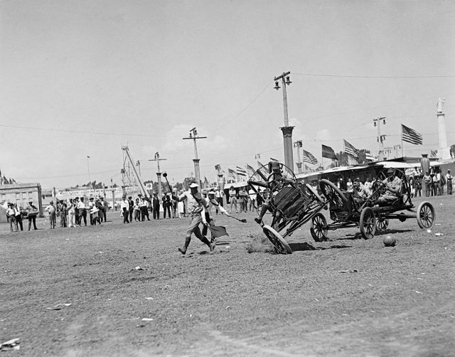 Men running away from a tipping vehicle