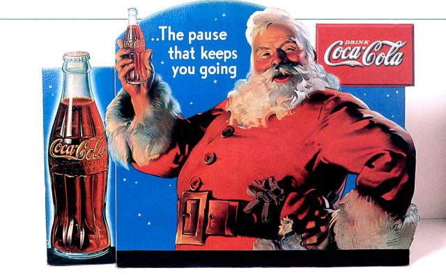 Santa Claus holding a bottle of Coca-Cola