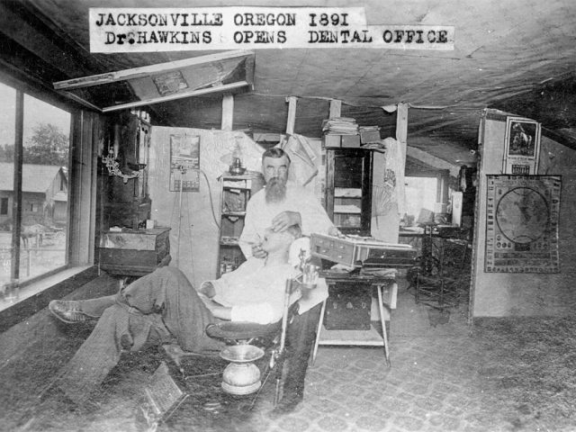 Dentist working on patient in Jacksonville Oregon, early 1890s. (Photo Credit: Mark Jay Goebel/Getty Images)