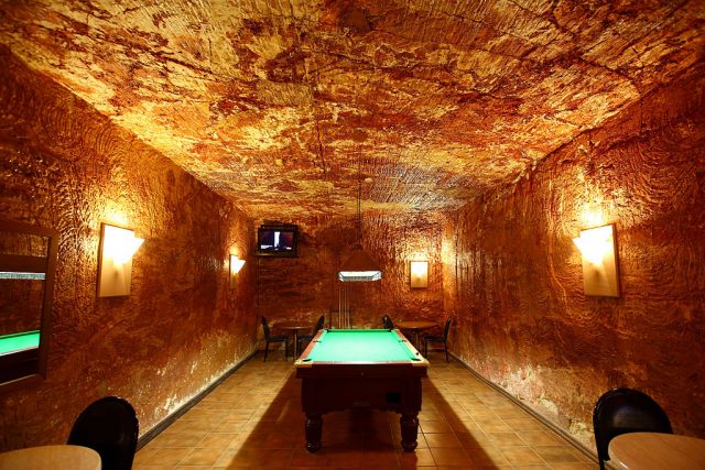 Pool table in the middle of an underground room