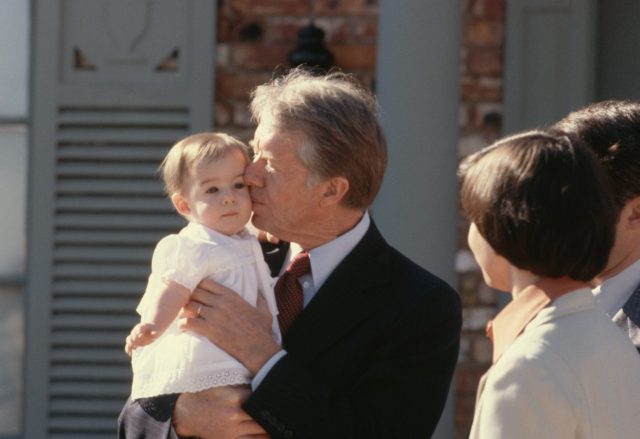 Jimmy Carter kisses a baby 
