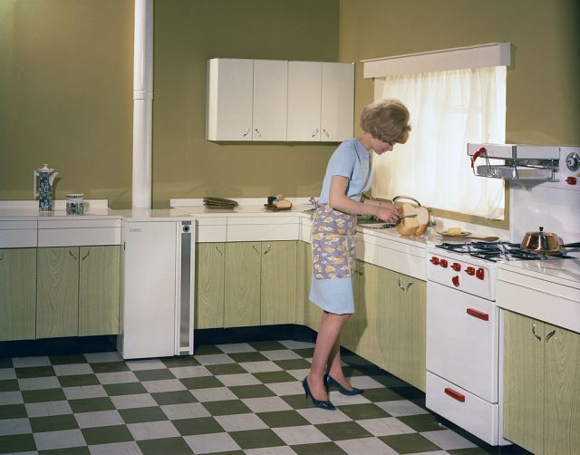 Woman buttering bread at a kitchen counter