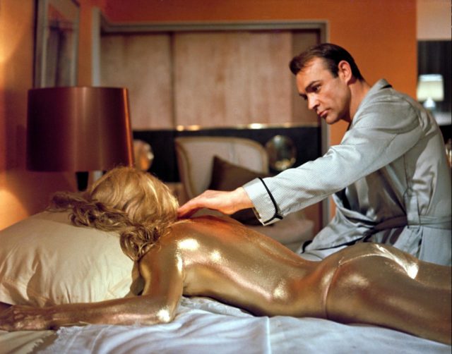 James bond sitting on a bed with jill masterson