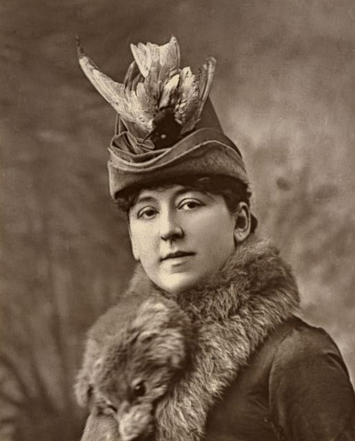 Amy Roselle wearing a hat with a bird atop it