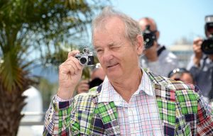 Bill Murray holding a tiny camera