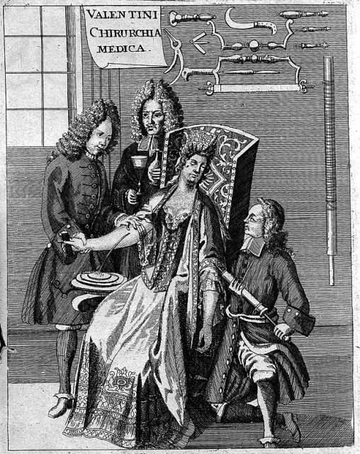 Three men standing around a woman who is undergoing bloodletting