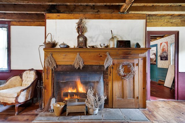 Wooden fireplace with the fire lit