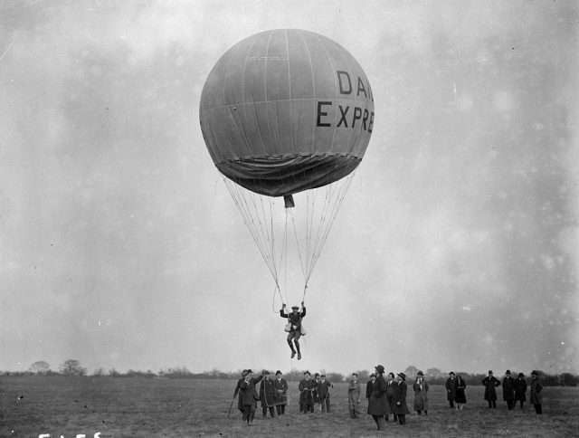 Balloon jumping at stag lane aerodrome. The participant is suspended in a harness under the balloon which appears to be sponsored by the daily express newspaper. (photo credit: fox photos/getty images)