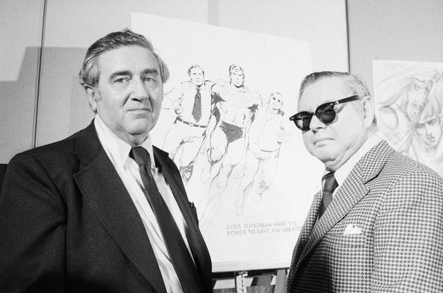 Superman creators Jerry Siegel and Joe Shuster pose in front of sketches of their creation. The pair signed away their rights to royalties for $65 apiece in 1938. (Photo Credit: Bettmann / Contributor)