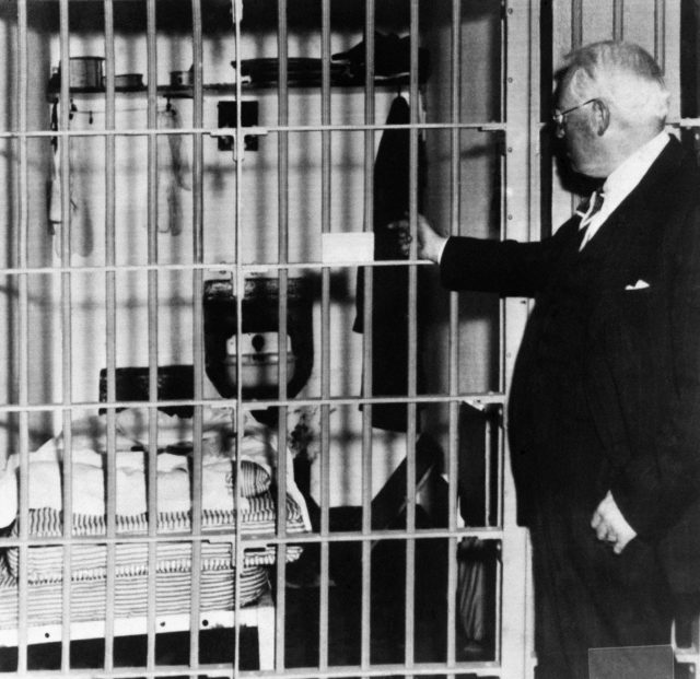 Warden Johnson in front of a cell 