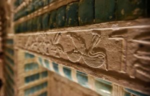 Hieroglyphic carvings surrounded by decorative tile