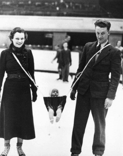 parents ice skating with their baby