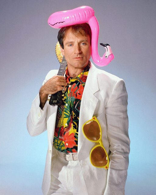 Robin Williams with a blow-up flamingo on his head