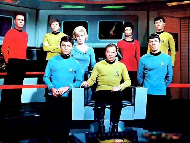 Cast of Star Trek: The Original Series sitting on the USS Enterprise