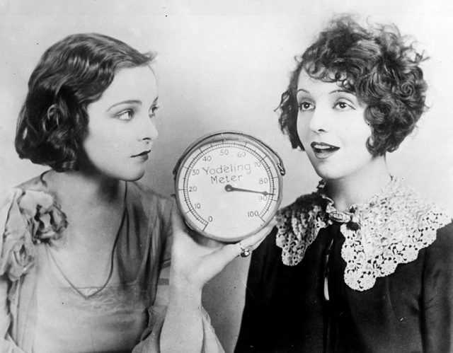 circa 1925: Sally Blane and Betty Jewel, try out the new Yodel meter, which measures the pitch of the human voice. (Photo Credit: General Photographic Agency/Getty Images)