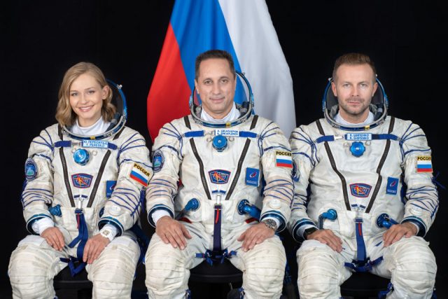 Yulia peresild, klim shipenko and anton shkaplerov sitting in spacesuits