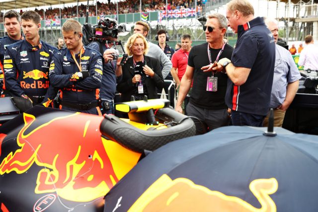 Actor Daniel Craig talks with Marek Reichman, Executive Vice President & Chief Creative Officer, Aston Martin Lagonda Ltd, next to the car of Pierre Gasly of France and Red Bull Racing on the grid before the F1 Grand Prix of Great Britain at Silverstone on July 14, 2019 in Northampton, England. (Photo Credit: Mark Thompson/Getty Images)