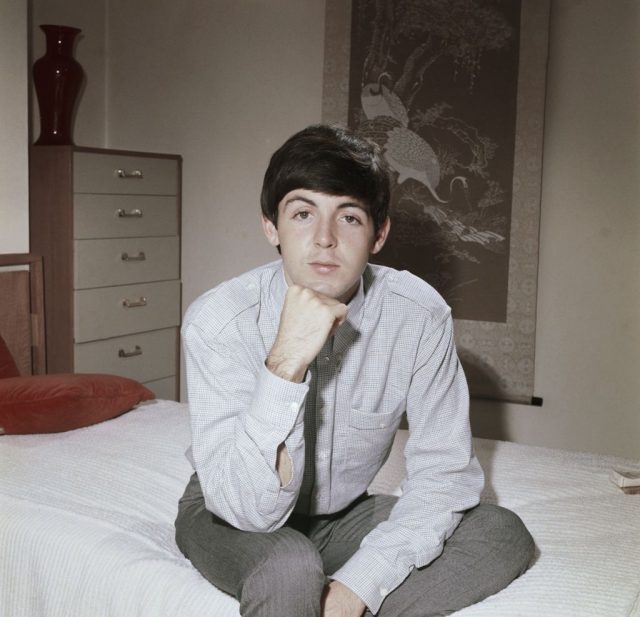 LONDON – CIRCA 1964: Bassist Paul McCartney of the rock band “The Beatles” poses for a portrait sitting on a bed in circa 1964 in London, England. (Photo Credit: Michael Ochs Archives/Getty Images)