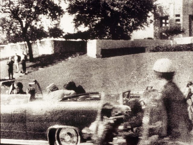 View of John F. Kennedy's car from behind following him being shot