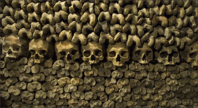 Wall of human skulls and femurs at the Catacombs of Paris