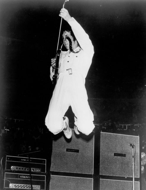 Pete Townshend jumping during a concert 