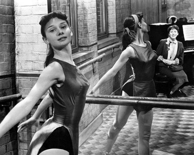 Audrey Hepburn striking a pose while practicing ballet