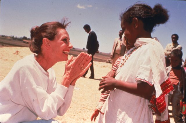 Audrey Hepburn smiling at a child in Ethiopia