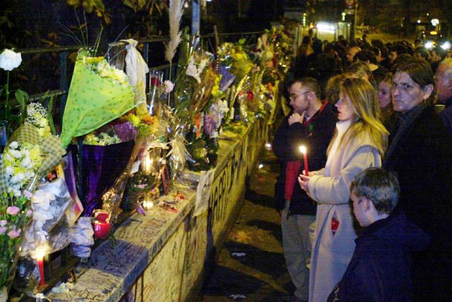 Fans gather around a makeshift memorial for George Harrison
