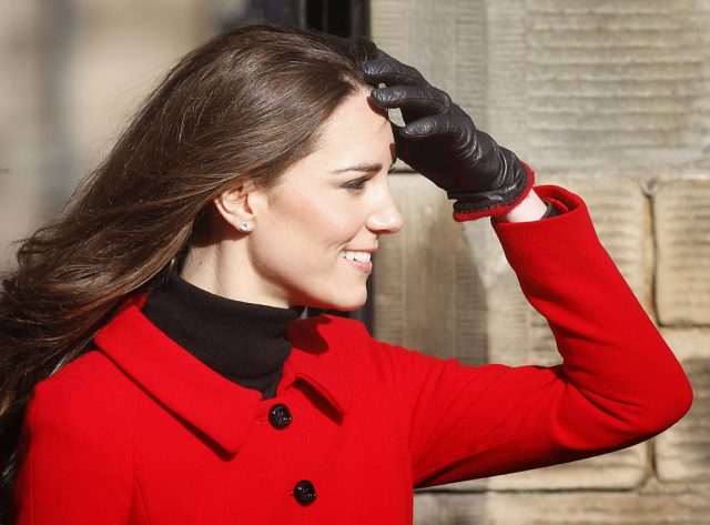 Kate Middleton shields her eyes during a visit to the University of St Andrews in Scotland on February 25, 2011 (Photo Credit: should read DANNY LAWSON/AFP via Getty Images)