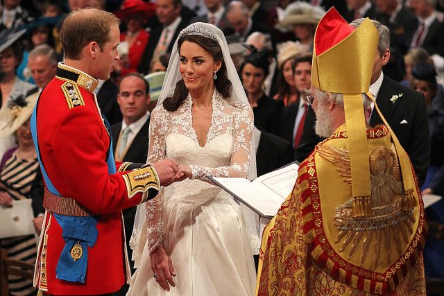 Prince William exchanges rings with his bride Catherine Middleton in front of the Archbishop of Canterbury Rowan Williams inside Westminster Abbey on April 29, 2011 in London, England. (Photo Credit: Dominic Lipinski – WPA Pool/Getty Images)
