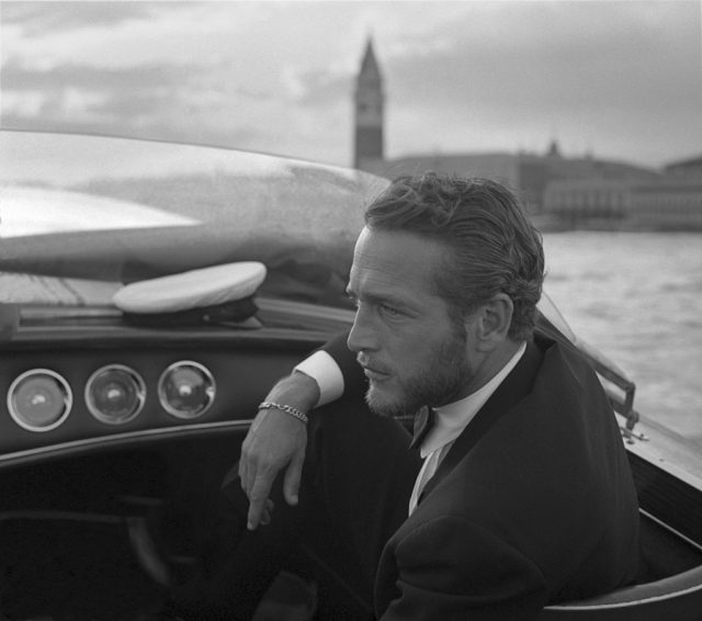 American actor Paul Newman, wearing a tuxedo and a bow tie, portrayed during a trip on a water taxi, a sailor cap on the dashboard, St. Mark Square in the background, Venice 1963. (Photo Credit: Archivio Cameraphoto Epoche/Getty Images)