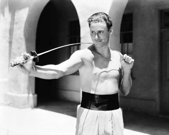 Australian-born american actor errol flynn (1909 – 1959) on the set of ‘captain blood’, directed by michael curtiz, 1934. (photo credit: silver screen collection/getty images)