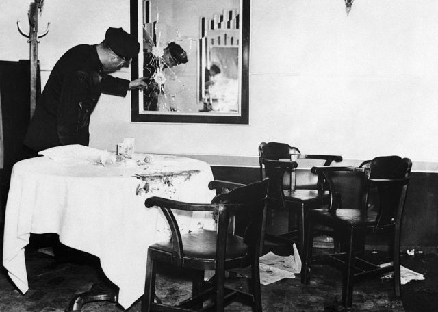 A Newark, New Jersey police officer examines a shattered mirror at the scene of the mob assassination of Arthur “Dutch Schultz” Flegenheimer. Flegenheimer and three of his bodyguards, Otto Berman, Leo Frank, and Bernard Rosenkrantz, were fired upon by two unknown gunmen as they were dining at the steakhouse. (Photo Credit: Bettmann / Contributor)