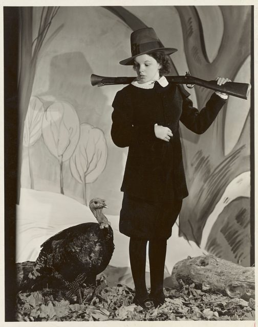 Judy Garland looking wearily at a turkey