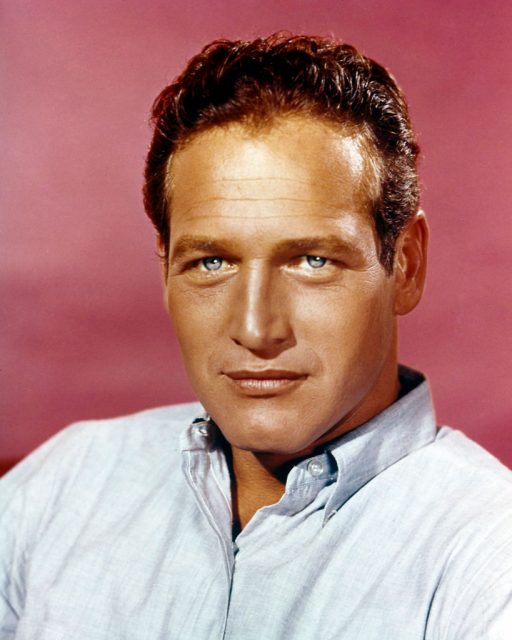 Portrait of American actor Paul Newman as he poses against a pale red background, 1960s. (Photo Credit: Silver Screen Collection/Getty Images)