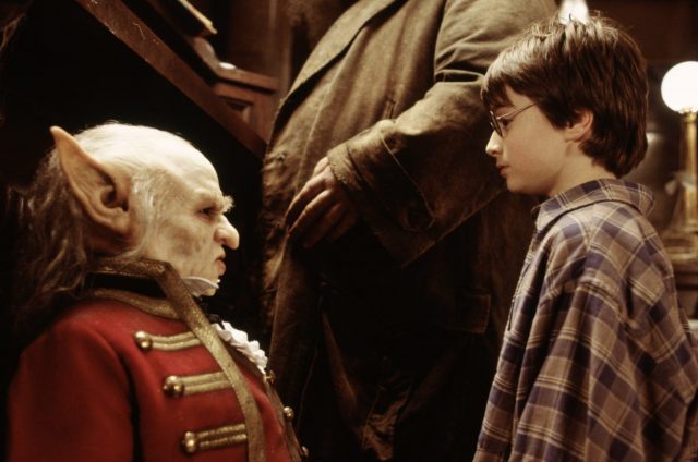 Harry Potter staring at a Gringotts goblin