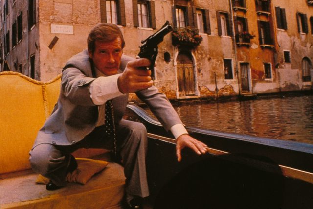 James Bond crouching while holding a gun