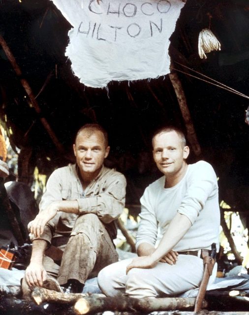 John Glenn and Neil Armstrong sitting on the ground