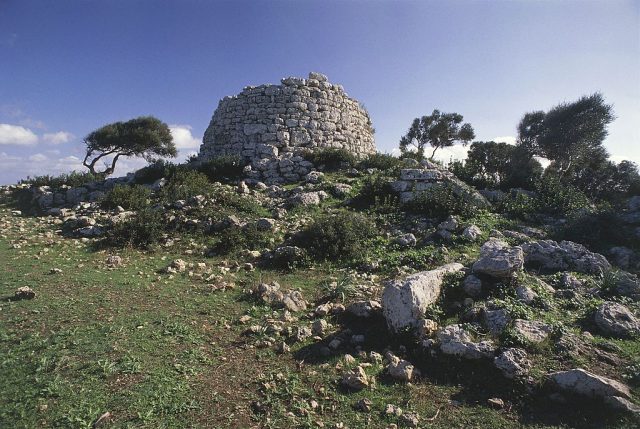 Ruins of a talaiot on a grassy hill