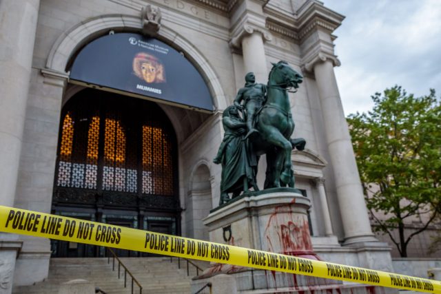 Police tape surrounding the Theodore Roosevelt statue after it was covered in fake blood