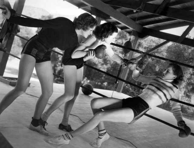 Virginia Carroll, Maxine Jenning and Jane Hamilton sparring in a boxing ring