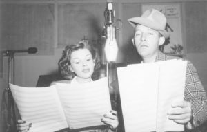 Photograph of Judy Garland and Bing Crosby singing