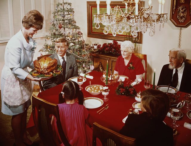 Mother serving Christmas dinner to her family