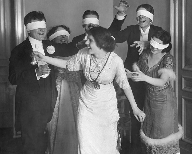 Men and women enjoying parlour games