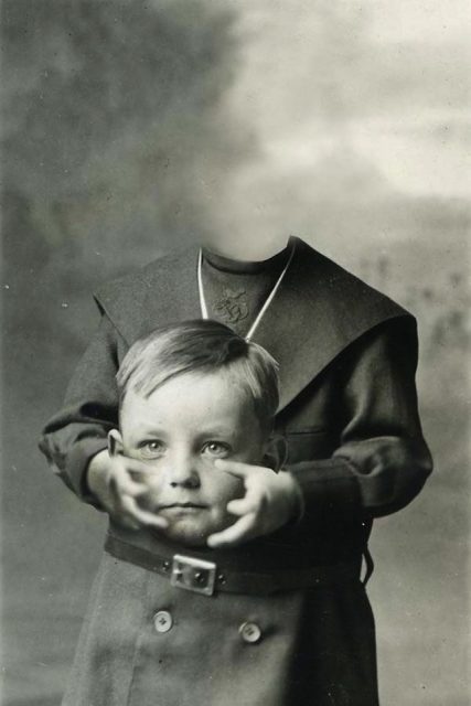 Male child holding his head in his hands