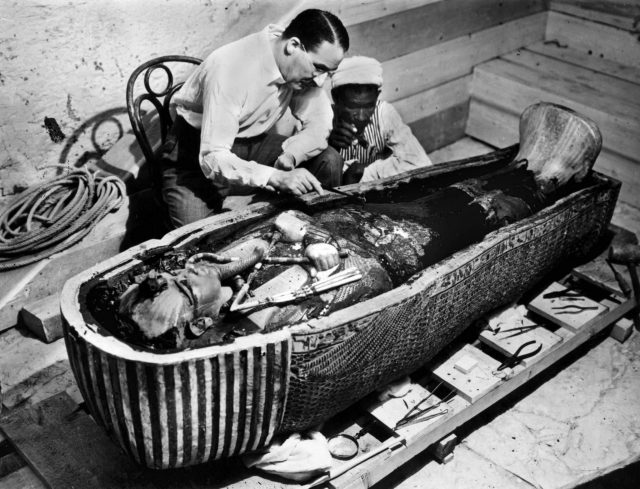 Howard Carter looking at King Tut's sarcophagus 