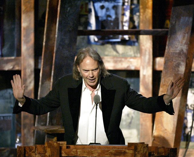 Neil Young speaking at a podium
