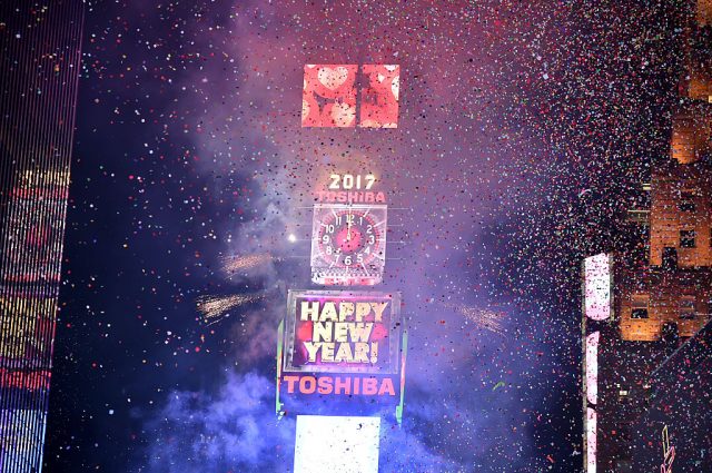New Year's clock surrounded by confetti