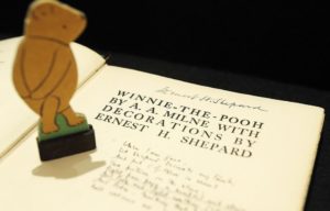 Winnie-the-Pooh figurine atop an open book